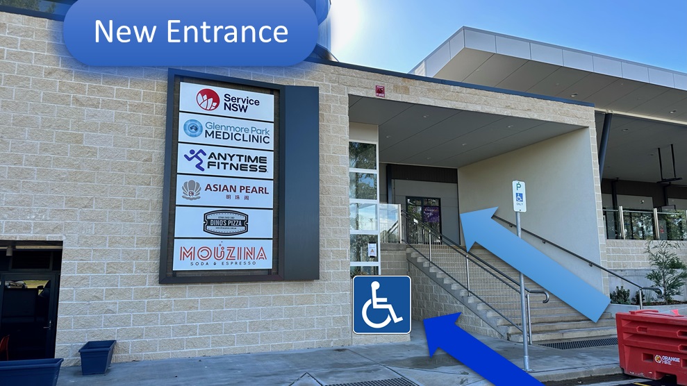 The ground-floor entrance with the directory board listing Service NSW, Glenmore Park Mediclinic and neighbouring shops, and the marked route toward the stairs